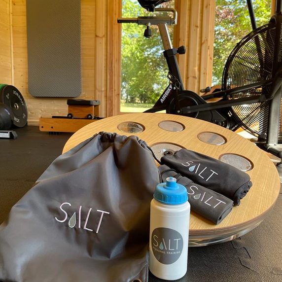 Kettlebells, resistance bands and a balance board with a SALT kit bag inside the studio